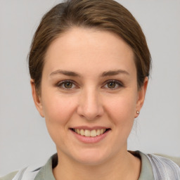 Joyful white young-adult female with short  brown hair and grey eyes