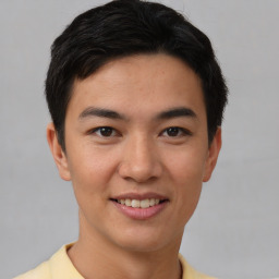 Joyful asian young-adult male with short  brown hair and brown eyes