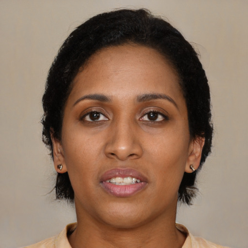 Joyful black young-adult female with medium  black hair and brown eyes
