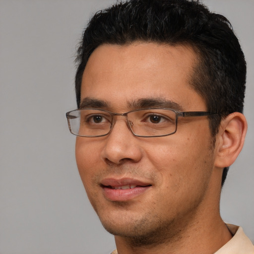 Joyful white adult male with short  black hair and brown eyes