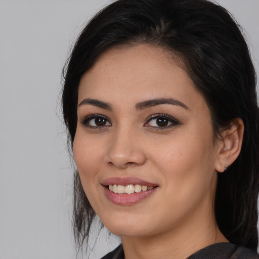 Joyful white young-adult female with medium  black hair and brown eyes