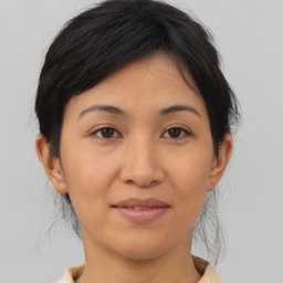 Joyful asian young-adult female with medium  brown hair and brown eyes