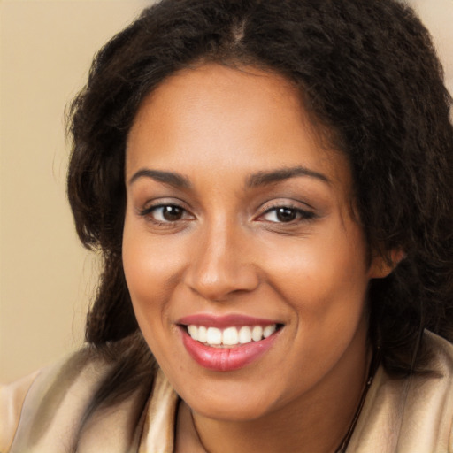 Joyful latino young-adult female with long  brown hair and brown eyes