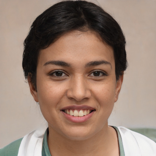 Joyful white young-adult female with short  black hair and brown eyes