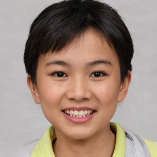 Joyful asian child female with short  brown hair and brown eyes