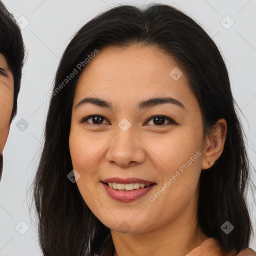 Joyful asian young-adult female with long  brown hair and brown eyes