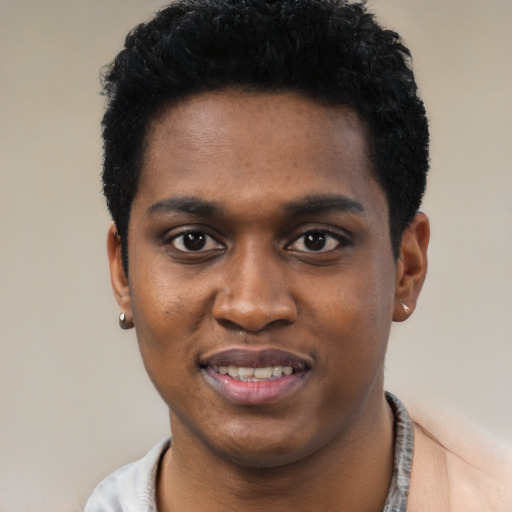 Joyful black young-adult male with short  black hair and brown eyes
