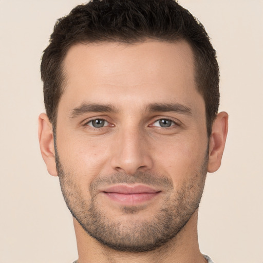 Joyful white young-adult male with short  brown hair and brown eyes