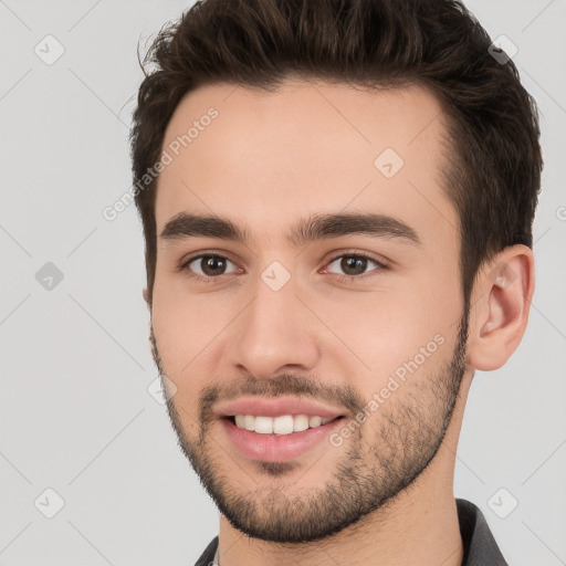 Joyful white young-adult male with short  brown hair and brown eyes