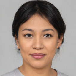 Joyful asian young-adult female with medium  black hair and brown eyes