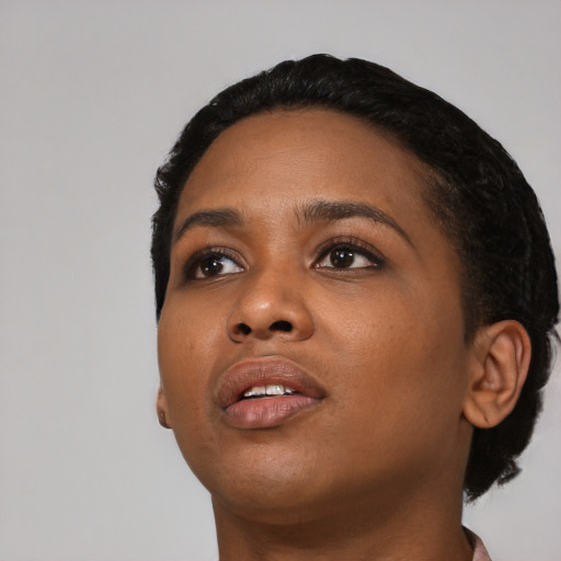 Joyful black young-adult female with short  black hair and brown eyes