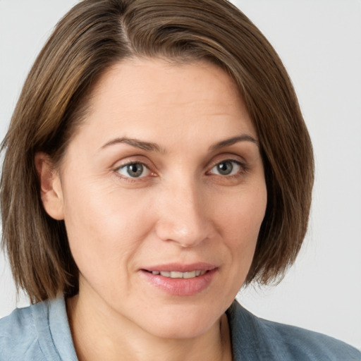 Joyful white young-adult female with medium  brown hair and blue eyes