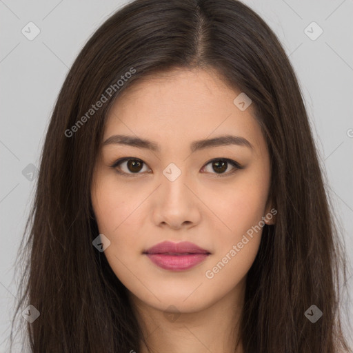 Joyful asian young-adult female with long  brown hair and brown eyes