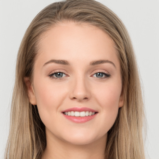 Joyful white young-adult female with long  brown hair and grey eyes