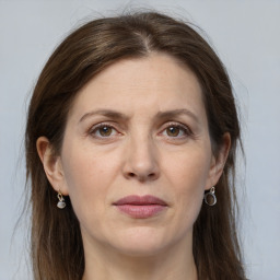 Joyful white adult female with long  brown hair and grey eyes