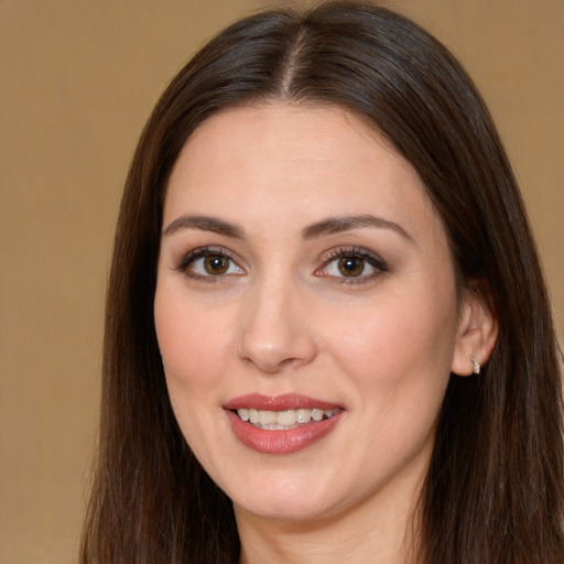 Joyful white young-adult female with long  brown hair and brown eyes