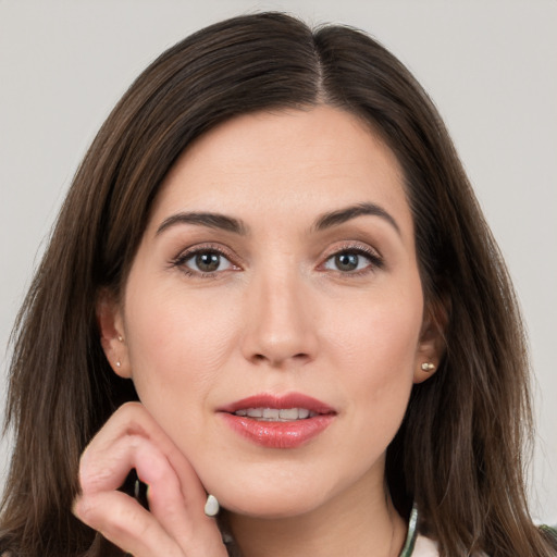 Joyful white young-adult female with long  brown hair and grey eyes