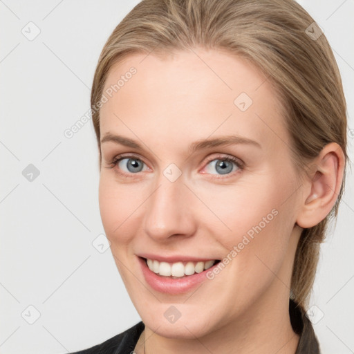 Joyful white young-adult female with medium  brown hair and blue eyes