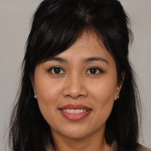 Joyful asian young-adult female with long  brown hair and brown eyes