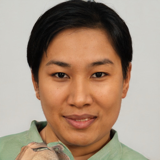 Joyful asian young-adult female with short  brown hair and brown eyes