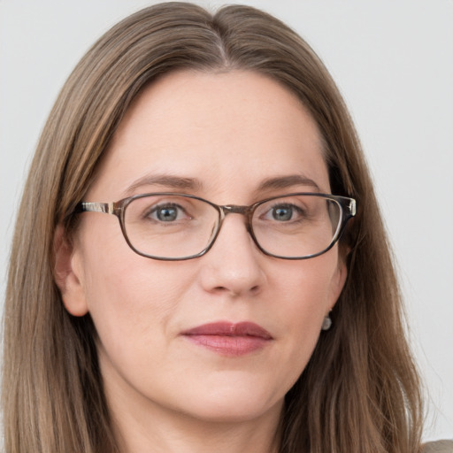 Joyful white adult female with long  brown hair and grey eyes