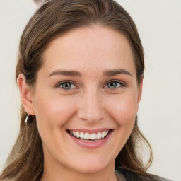 Joyful white young-adult female with long  brown hair and blue eyes