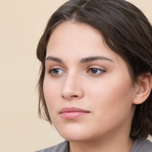 Neutral white young-adult female with medium  brown hair and brown eyes