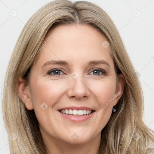 Joyful white adult female with long  brown hair and grey eyes