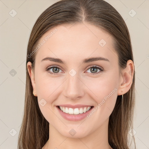 Joyful white young-adult female with long  brown hair and blue eyes