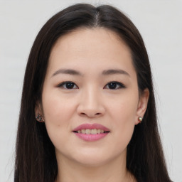 Joyful asian young-adult female with long  brown hair and brown eyes