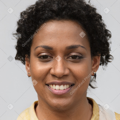 Joyful black young-adult female with short  brown hair and brown eyes