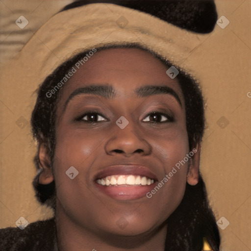 Joyful black young-adult female with long  brown hair and brown eyes