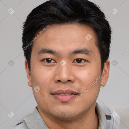 Joyful asian young-adult male with short  brown hair and brown eyes