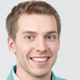 Joyful white young-adult male with short  brown hair and blue eyes