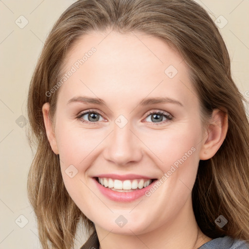 Joyful white young-adult female with long  brown hair and blue eyes