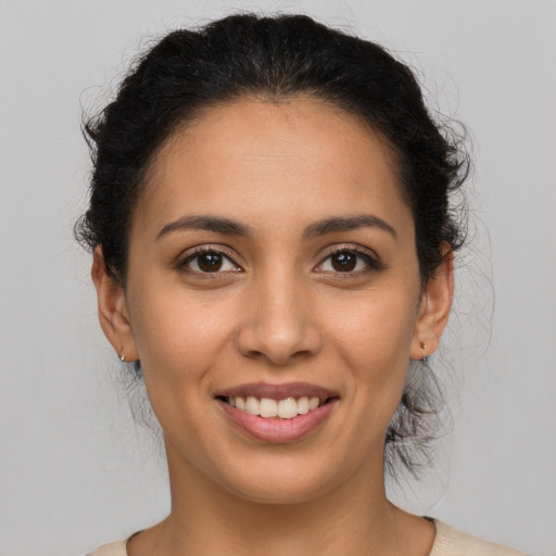 Joyful latino young-adult female with long  brown hair and brown eyes