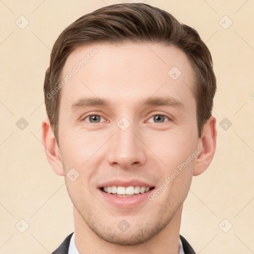 Joyful white young-adult male with short  brown hair and grey eyes