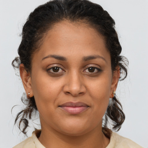 Joyful latino young-adult female with medium  brown hair and brown eyes