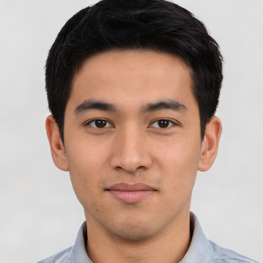 Joyful asian young-adult male with short  black hair and brown eyes