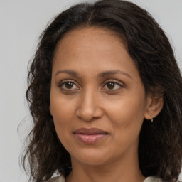 Joyful black adult female with medium  brown hair and brown eyes