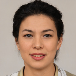 Joyful latino young-adult female with medium  brown hair and brown eyes