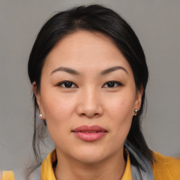 Joyful asian young-adult female with medium  brown hair and brown eyes