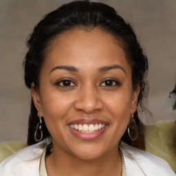 Joyful latino young-adult female with medium  brown hair and brown eyes