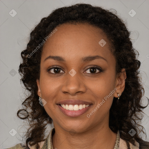 Joyful black young-adult female with long  brown hair and brown eyes