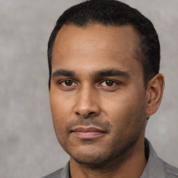 Neutral latino young-adult male with short  black hair and brown eyes