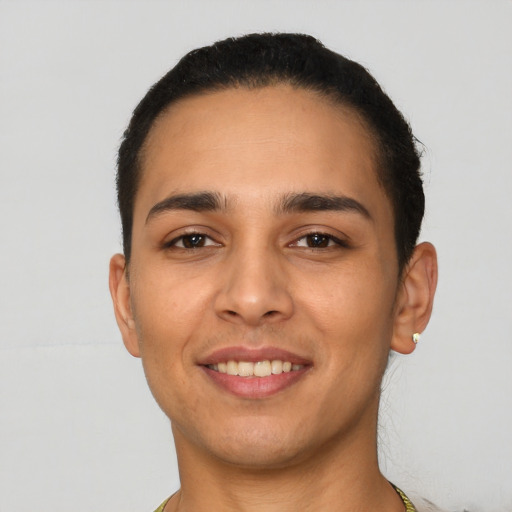 Joyful latino young-adult male with short  black hair and brown eyes