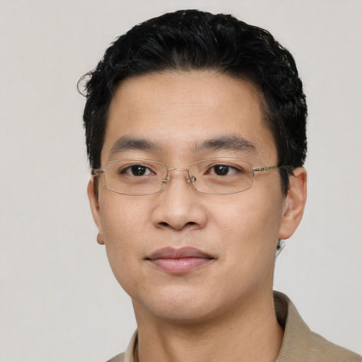 Joyful asian young-adult male with short  black hair and brown eyes