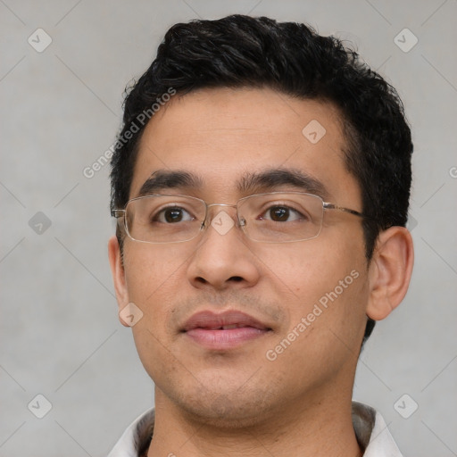 Joyful latino young-adult male with short  brown hair and brown eyes