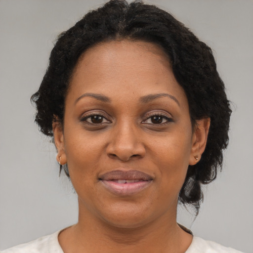 Joyful black adult female with short  brown hair and brown eyes