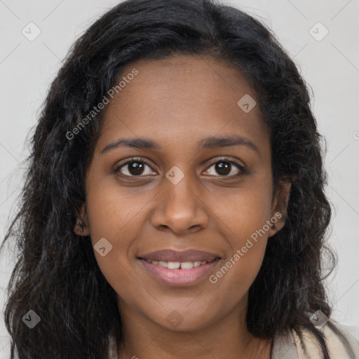 Joyful black young-adult female with long  brown hair and brown eyes